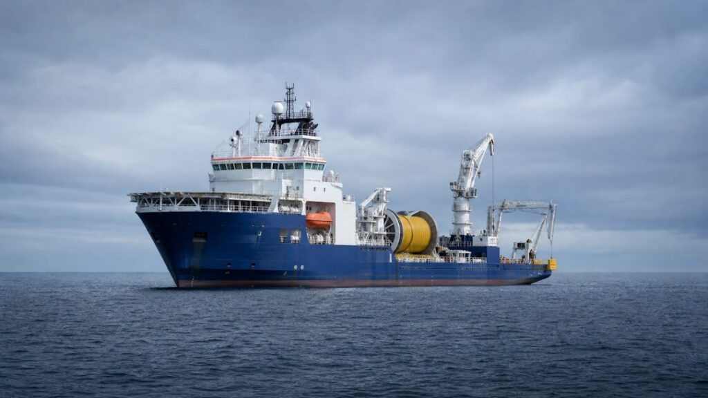 A cable-laying ship at sea, part of the fragile infrastructure carrying 97% of global internet traffic.